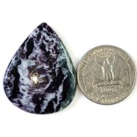Natural Kammererite cabochon featuring a soft lavender to deep magenta color with a silky sheen and smooth polished finish.