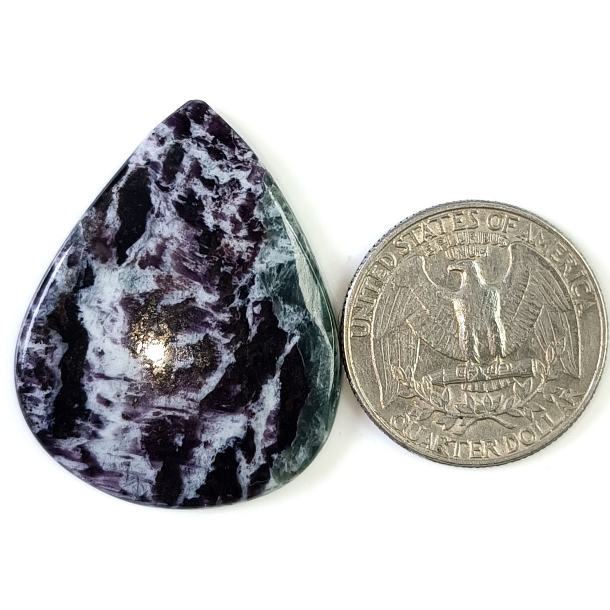 Natural Kammererite cabochon featuring a soft lavender to deep magenta color with a silky sheen and smooth polished finish.