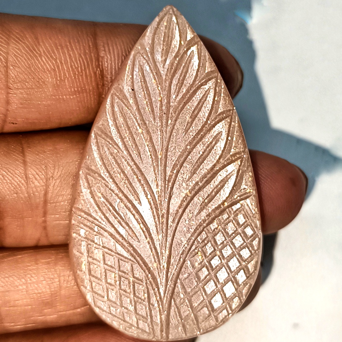 Hand Carved Peach Moonstone with Sunstone inclusions 47×27mm polished cabochon for jewelry making and crystal healing.