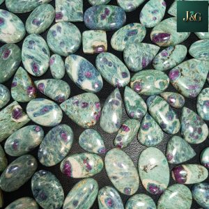 Natural Ruby Fuchsite cabochons with polished dome tops and flat backs for easy setting. Wholesale lots available, perfect for jewelers, artisans, and crystal lovers.